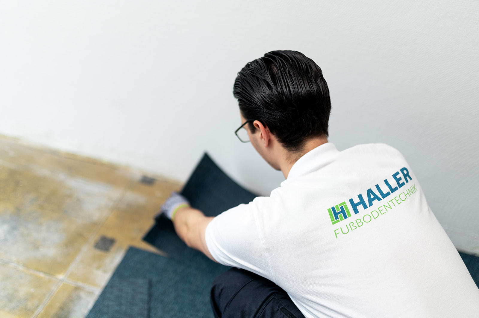 A worker laying laminate flooring